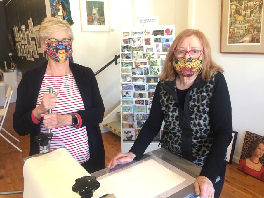 SOLD OUT: Robin Ezra (right), from the Printmaking Sisters, masked up to teach some skills to student Margaret Higgins.