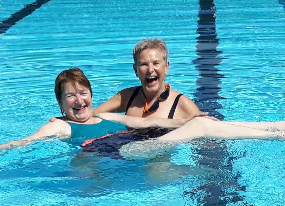 LIFE LOVER: Coby Koster (pictured holding her sister Wilma Koster) swims regularly for her health and sanity, and is worried Mittagong Pool won't be available this summer.