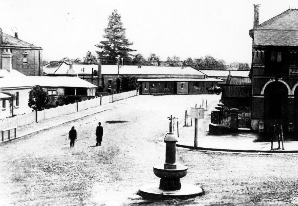 CENTRE OF TOWN: The Queen Victoria fountain at Moss Vale, c1900, with Court House (left), Post Office (right) and railway station (centre back) in view. Photo: BDH&FHS.