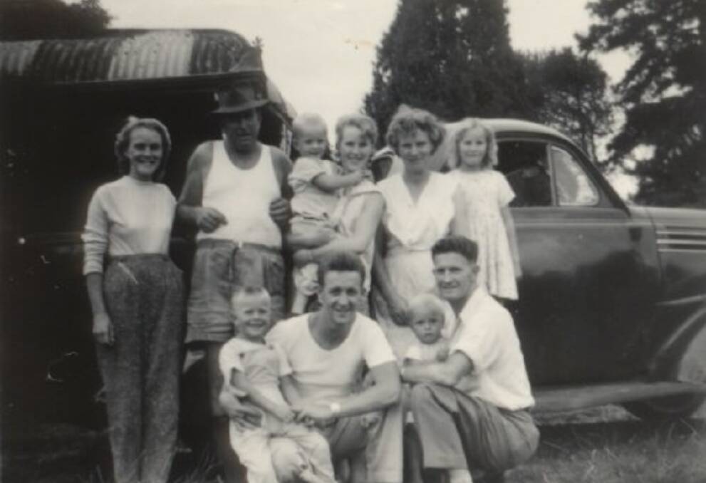 Ronald in his father's arms (lower right) with family members, 1959.
