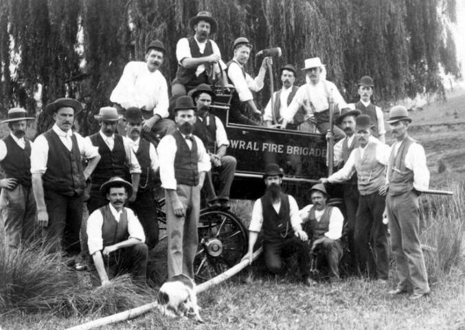 OFF-DUTY: Bowral Fire Brigade members with an early pump cart engine, c1900. Photo: BDH&FHS.
