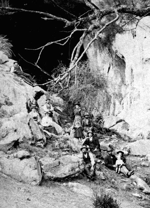 CAVERNOUS: A group of visitors outside the vast entrance chamber at Wombeyan Caves, which house a set of natural wonders. Photo: BH&FHS.