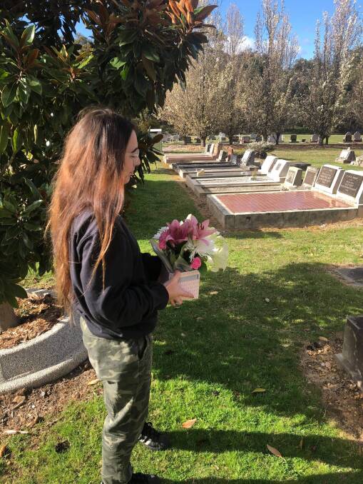 Sophie McDonagh visiting the grave of her friend, where gifts have gone missing.