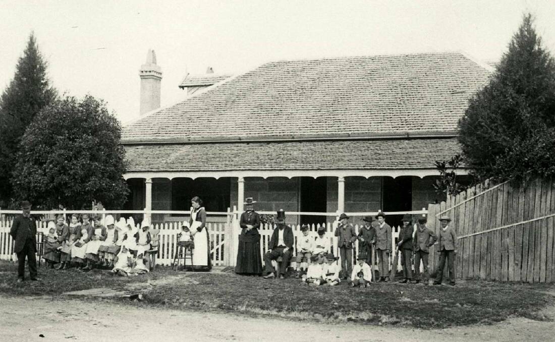 BEFORE FIRE: Children of No 3 Cottage Home with Nurse Graham (centre) and visitors, 1903. Photo supplied by BDH&FHS