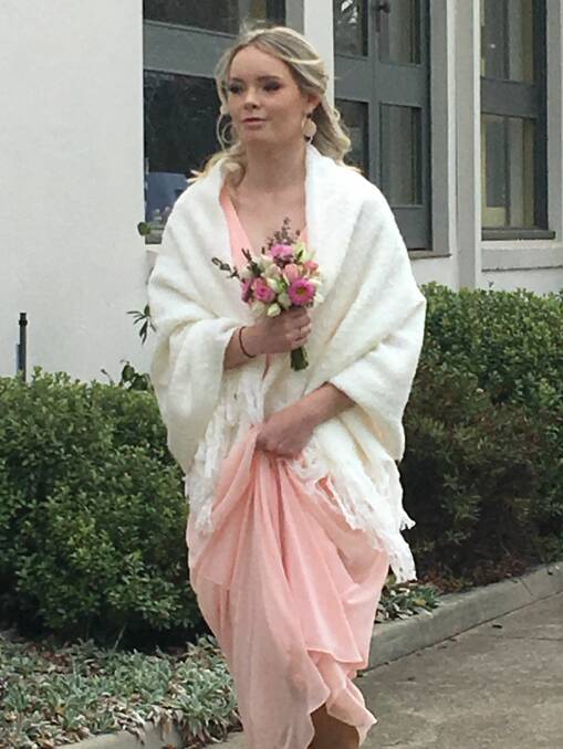 pretty in pink: Maid of honour Lily arrives in her soft, pink dress.