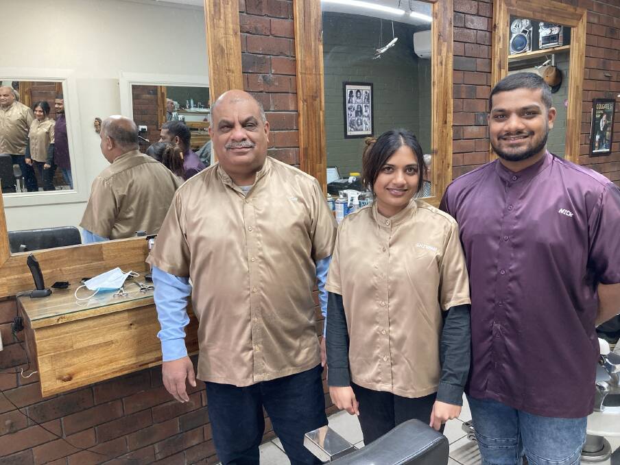 Asish Kumar and his children Shivana and Nikhil represent the fourth and fifth generations of their family to go into barbering. Photo: Michelle Haines Thomas