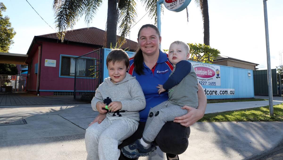 HAPPY: Liz Jennings with sons Jack Grindle and Lachlan Grindle outside Boombalee Kidz in Wollongong. Ms Jennings is happy to pay for childcare and is happy free childcare is ending. Picture: Robert Peet