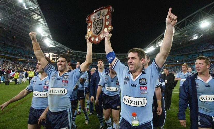 GLORY DAYS: Trent Barrett and Brad Fittler hold the state of Origin trophy after NSW won in 2004. Picture: Craig Golding