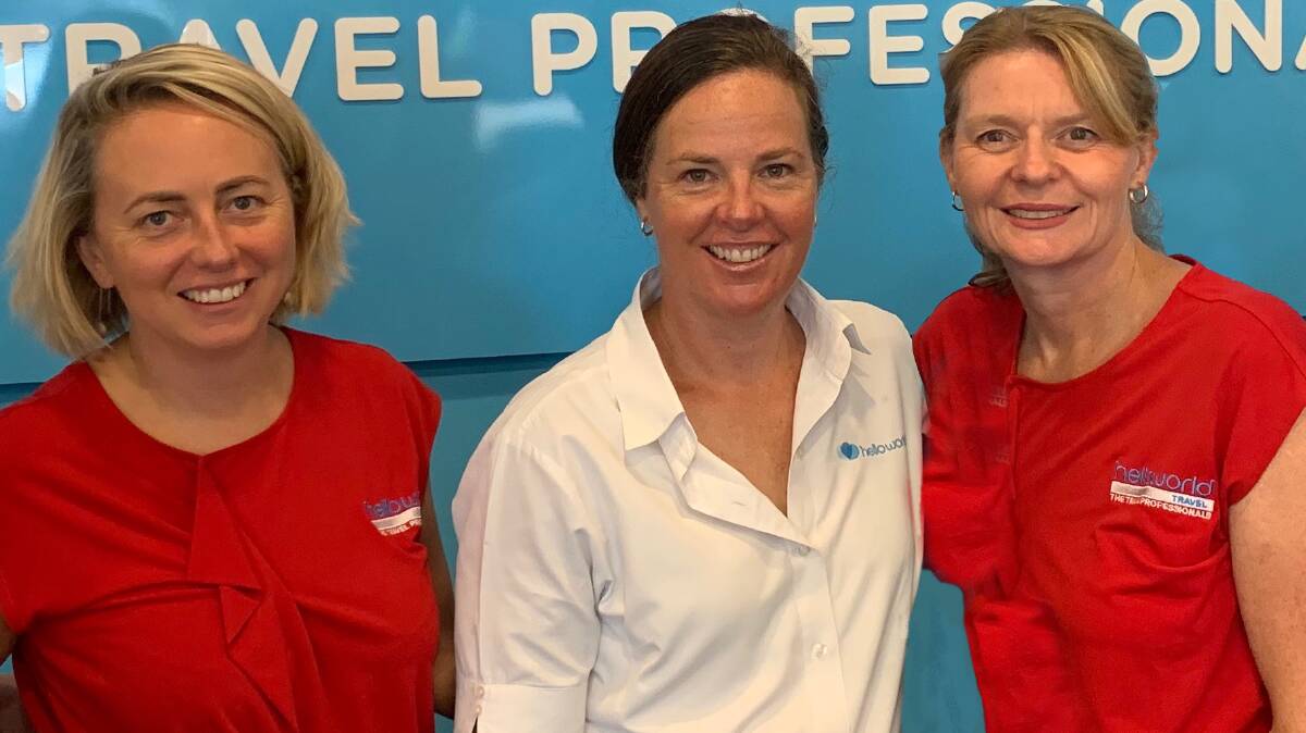 Verona Kite (centre), manager of Helloworld Travel Bowral, with Prue Wade and Deborah Molina. All three have been with the agency for 15 years. Picture supplied.