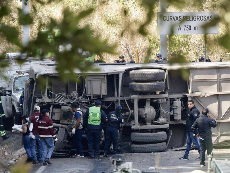 At least 18 people have been killed and dozens more injured after a bus tipped over in Mexico. (EPA PHOTO)