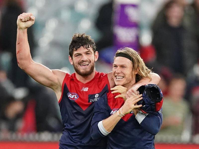 Angus Brayshaw (l) is one of Melbourne's AFL players sacrificing his own game for team team success.