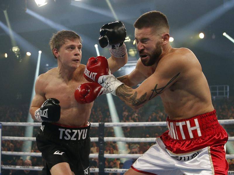 Nikita Tszyu lands another big punch on outgunned Mason Smith during their super-welterweight clash.
