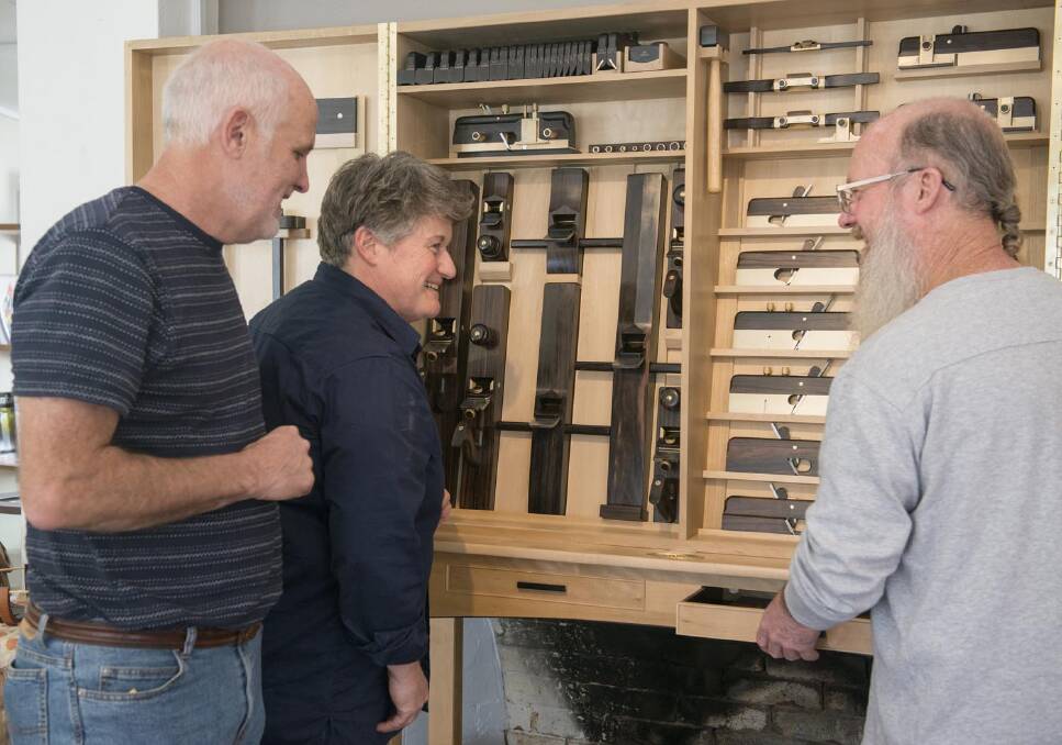 Fine furniture maker Phoebe Everill, centre, and custom tool makers Terry Gordon, left, and Colen Clenton inspect their handiwork, the aptly titled Collaboration One, on show at Sturt in Mittagong until March.	 Photo supplied