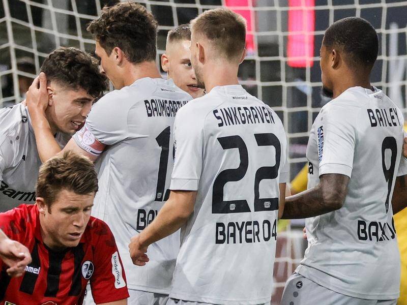 Leverkusen's Kai Havertz (l) is hailed by his teammates after scoring the winner against Freiburg.
