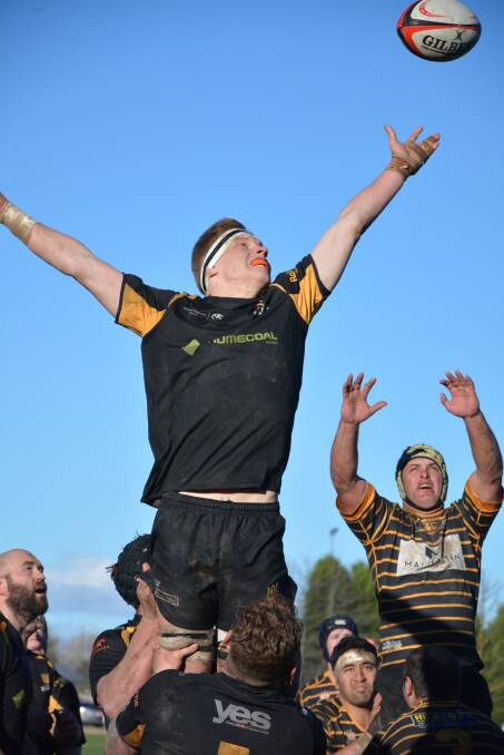 Jack Parsons flies high to catch the ball for Bowral. Photo: Mindy Hindmarsh
