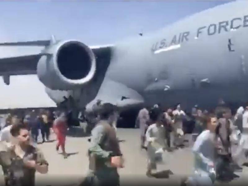 A body has been found in the landing gear of a plane that left Kabul amid chaotic scenes on Monday.
