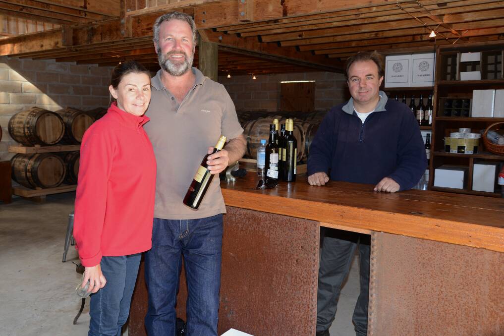 Stephanie and Matt Blatch with a bottle of Oloroso wine and Val Jimenez behind the bar. 
	Photo by Roy Truscott