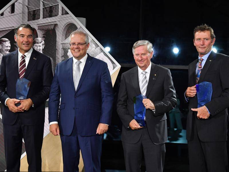Prime Minister Scott Morrison poses with three of the four Australian of the Year category winners.