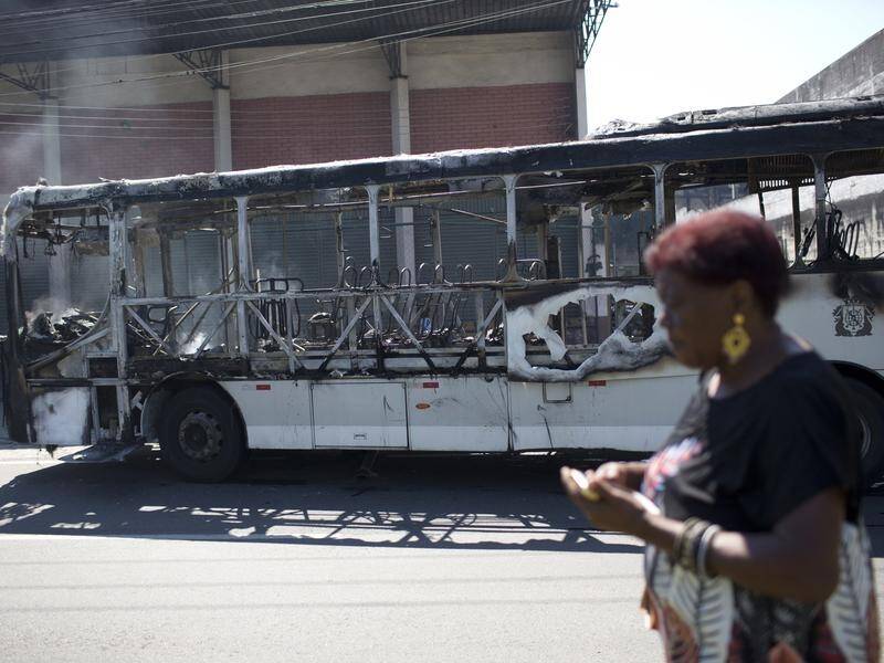 Violence in Rio de Janeiro has resulted in buses being torched and 13 people dying in shootouts.
