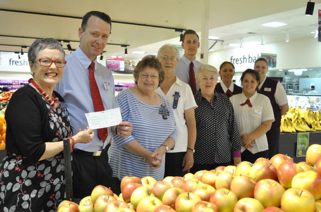 Moss Vale president Jennifer Bowe recieves a cheque from Ashcroft's IGA Moss Vale manager Brad Payten. CWA Moss Vale vice-president Colleen Urquhart, CWA members Doreen Peace and Lynette Croom with IGA staff members Shane Pritchard, Jane Bailey, Donna Moran and Nicole Maquire. Photo by Emma Biscoe