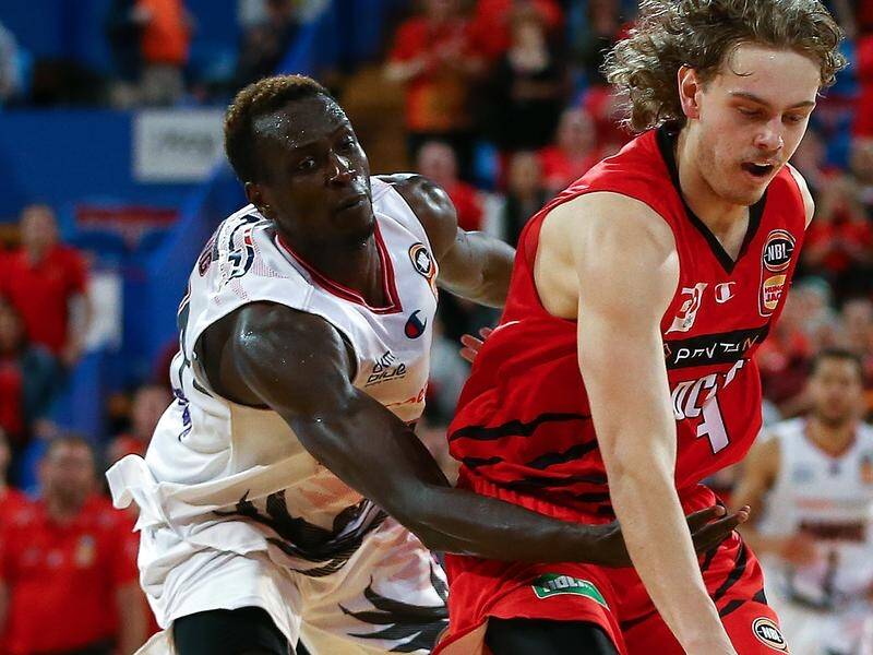 Luke Travers of the Wildcats holds off Deng Deng of the Hawks during their NBL match.