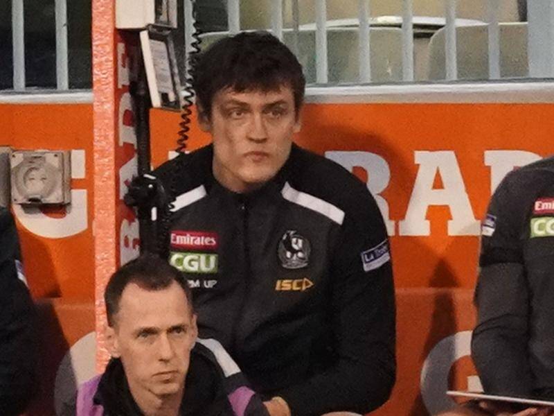 Collingwood's Darcy Moore sits on the bench, coming off during the Magpies' win against Essendon.