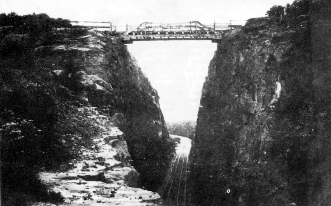 DEEP CUT: An 1870s view of the rail line through the Big Hill Cutting with timber bridge above. Photo: BDH&FHS