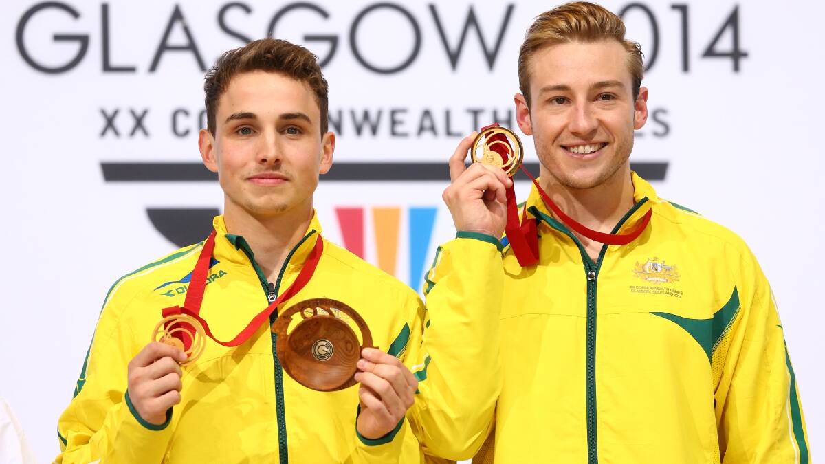 Diving gold medallists Domonic Bedggood and Matthew Mitcham flash their Commonwealth Games bling on Day 9. Photo: Quinn Rooney, Getty Images Sport.