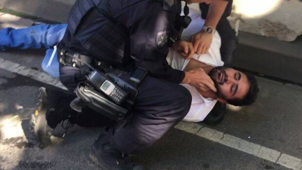 Police arrest a man who was in the Suzuki Vitara that mowed down CBD pedestrians. Photo: @LachlanVe/Twitter
