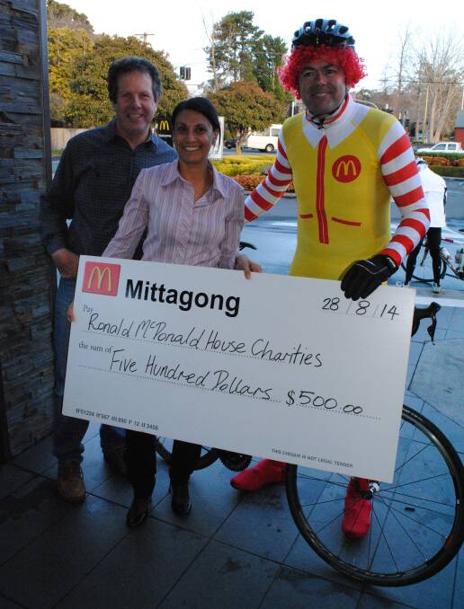 McDonald's Mittagong owners Marcelle and Peter Bain present a $500 cheque to Tony Aichinger, who received it on behalf of Ronald McDonald House Charities. 