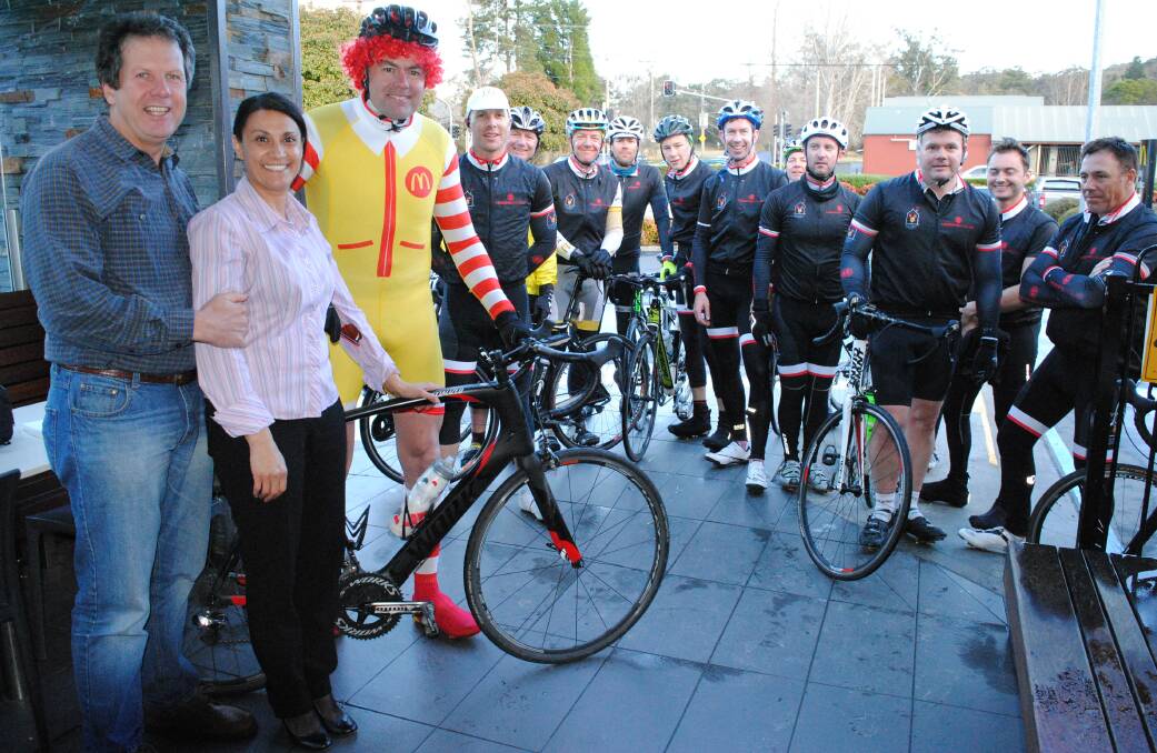 McDonald's Mittagong owners Marcelle and Peter Bain congratulate Tony Aichinger (dressed as Ronald McDonald) and crew for completing Thursday's leg of the Ronald McDonald House Charities Ride for Sick Kids NSW.
