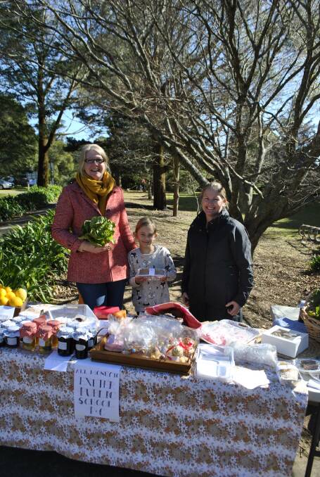 Greer Worsley and Skye Pope were selling homemade items and fresh food at the Exeter polling booth with help from Alice (Year 3). Photo by Claire Fenwicke