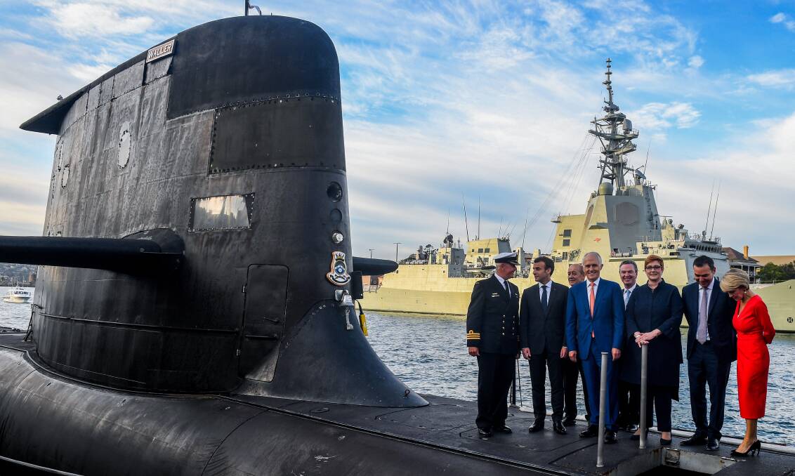 French President Emmanuel Macron (second from left) with former Australian prime minister Malcolm Turnbull and Australian ministers in 2018 on the Collins-class submarine HMAS Waller. Picture: Getty Images