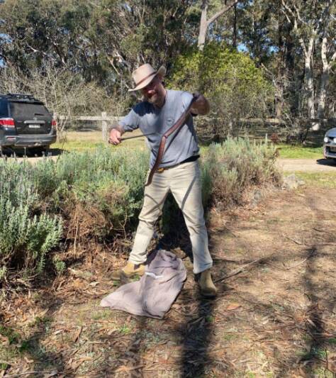 Ray McGibbon captures and relocates a Red-bellied snake from a property in Pensrose. Photo: Reptile Rescue, relocations, awareness, southernhighlands & surrounds Facebook page. 