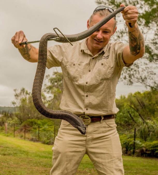 Ray McGibbon with a rescued snake. Pic: Supplied 
