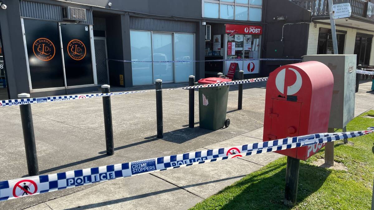 A large area was cordoned off outside the Australia Post branch in Lake Heights following the armed hold-up. Picture by Nadine Morton 