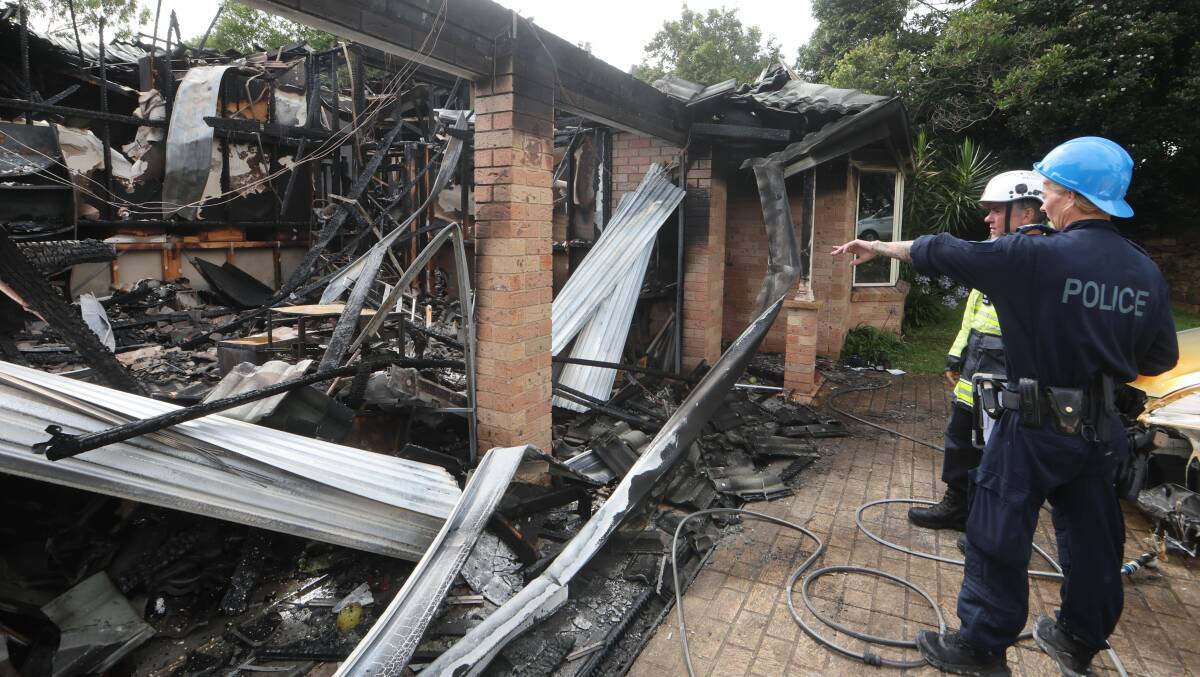 Investigators at the burnt-out home on Cullen Drive at Kiama Downs on Tuesday, January 9, 2024. Picture by Sylvia Liber