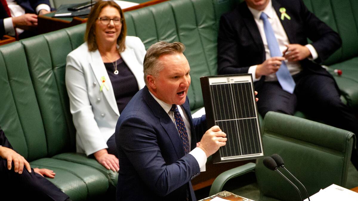 Labor climate and energy spokesman Chris Bowen holds up a solar panel during debate in the federal Parliament. Picture: Elesa Kurtz