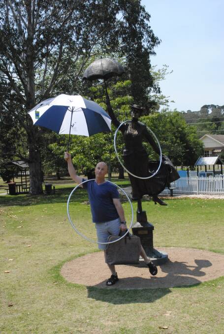 Former hula-hoop world champion and Mary Poppins collector poses with the statue. Photo by Megan Drapalski