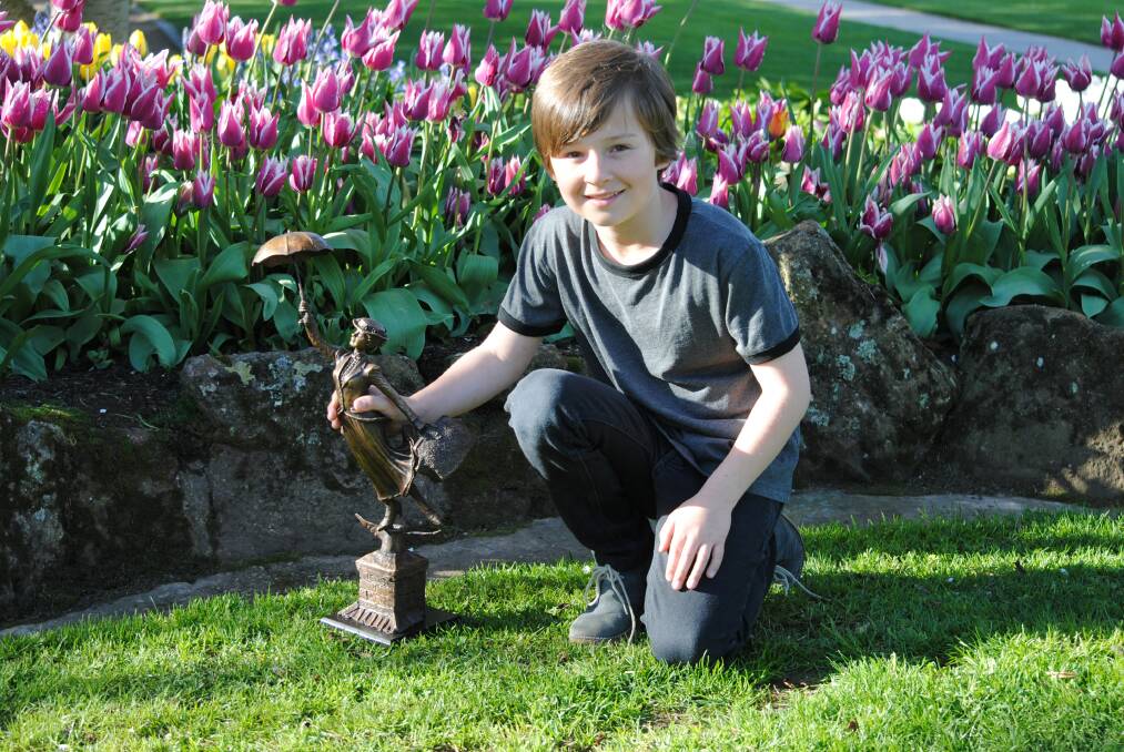 Photo by Dominica Sanda. Nine-year-old Archie Hancock with a smaller replica of the Mary Poppins statue.