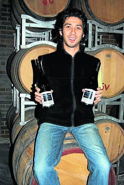 Winemaker Jonathon Holgate proundly shows off two of the award-winning Tertini wines. Photo Linda Lambrechts