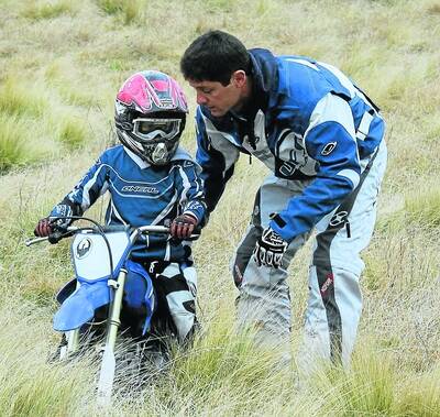 Andrew Endersby from Mittagong guiding son Eden at the proposed trail bike camping experience at 'The Farm', Tugalong.