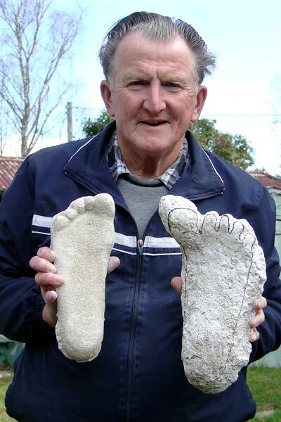 “Yowie Man” Rex Gilroy with a cast of hist right foot compared with a left opposable big-toed Australopithecine-type footprint, cast from a Blue Mountains location. There have been claims that such footprints have been found in the Bowral district for generations. Photo copyright © Rex Gilroy 2012.
