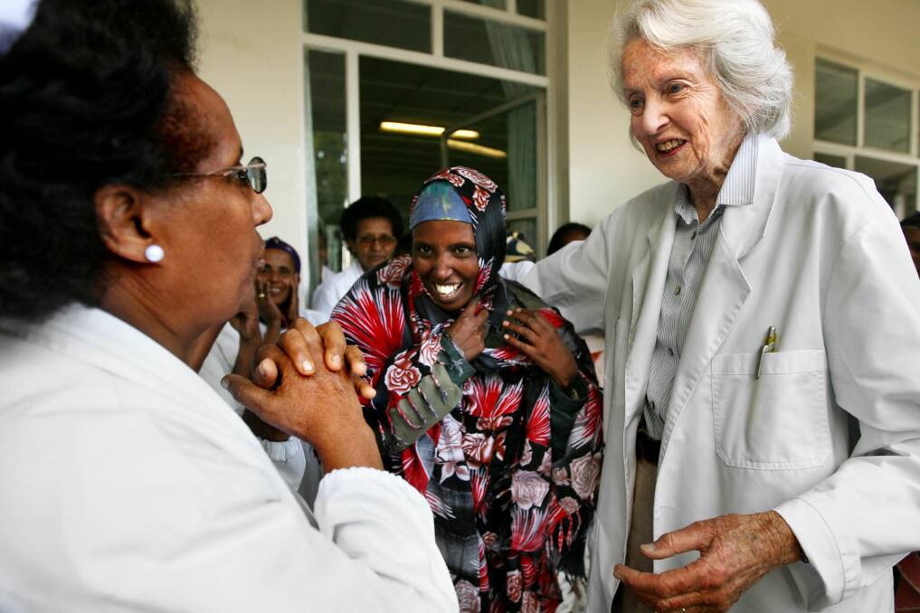Australian Dr Catherine Hamlin hugs fistula patient Habiba while talking to Sister Alem Tsehai during the dance of joy a ritual celebration on the eve of the women returning home cured.Photo by Kate Geraghty