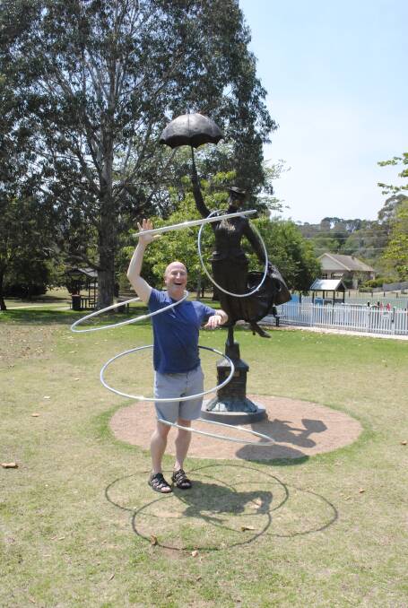 Former world champion hula-hoop artiste and Mary Poppins afficianado Mat Plendl shows off his skills in front of the Mary Poppins statue in Bowral. Photo by Megan Drapalski