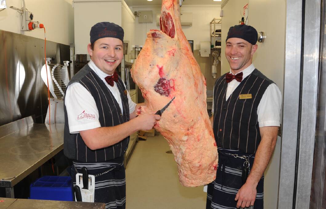 Butcher Simon Pyne and apprentice butcher Brian Wyatt hard at work after winning Meat and Livestock Australia's Best Retail Butcher Award. 	Photo by Roy Truscott