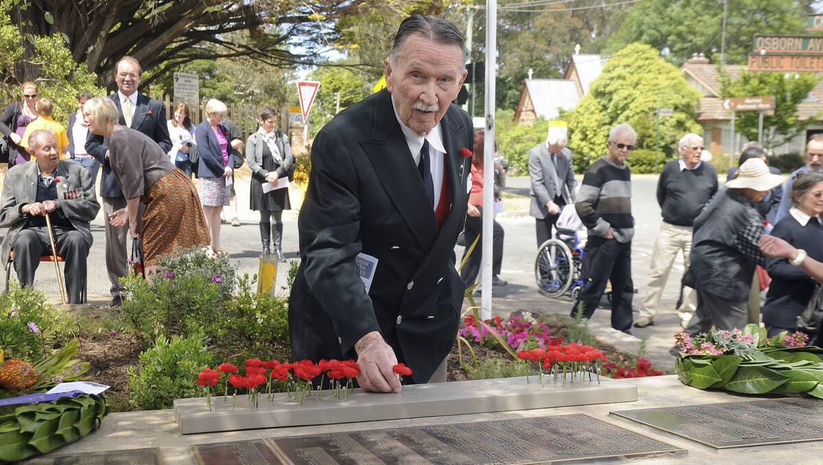 Albury Reynolds places a poppy at the young age of just 95.