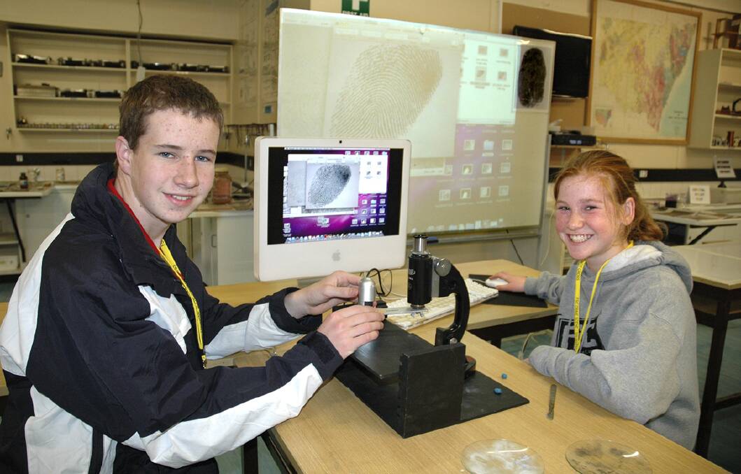 The Armidale School (TAS) Forensic Science Camp student director John Dennis and Rosie Scanlan, of Bowral, test for fingerprints at the Forensic Science Camp over the holidays. Photo supplied